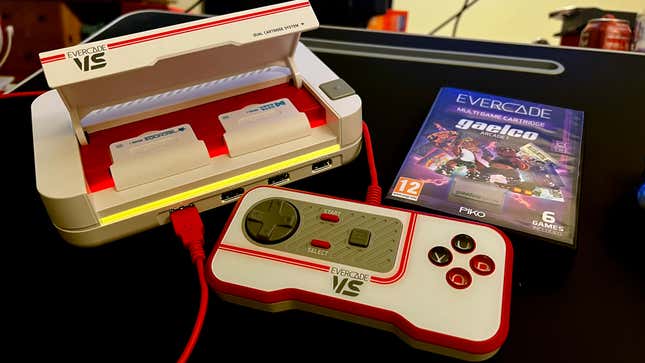 Photo of the Evercade VS retro gaming console, its cartridge slot open with two cartridges installed.